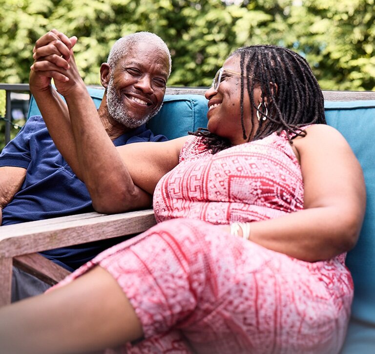 Bob and his wife, Cynthia, holding hands and smiling at one another