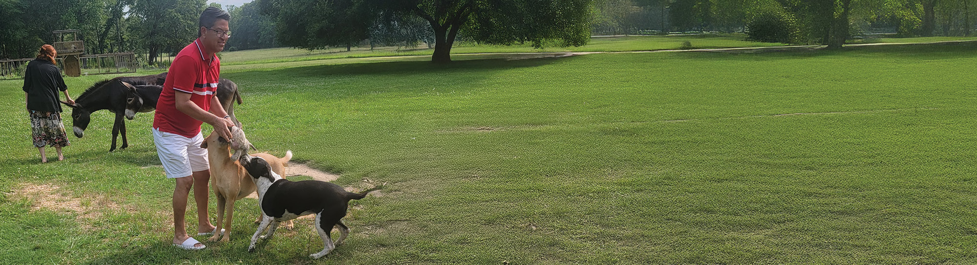 Leonard and his partner, Mark, playing with dogs
