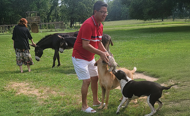Leonard and his partner, Mark, playing with dogs