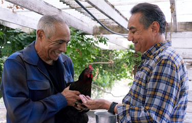 Richard, a patient living with early Alzheimer's, and his brother, smiling