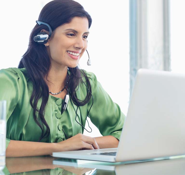 Woman from Eisai Patient Support smiling and talking on headset