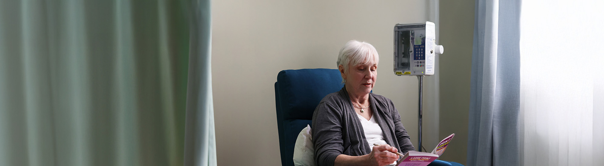 Nina reading a book at the infusion center.