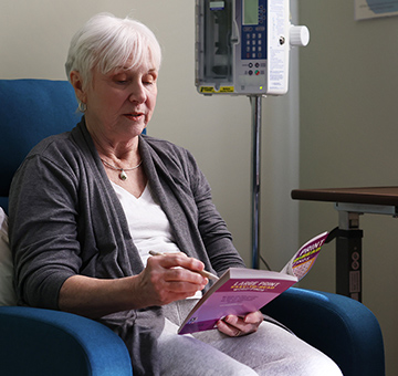 Nina reading a book at the infusion center.