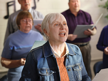 Nina with a group, singing