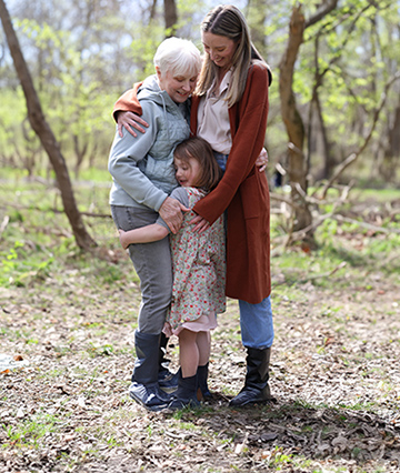 Nina, a patient living with early Alzheimer's, with her daughter and granddaughter