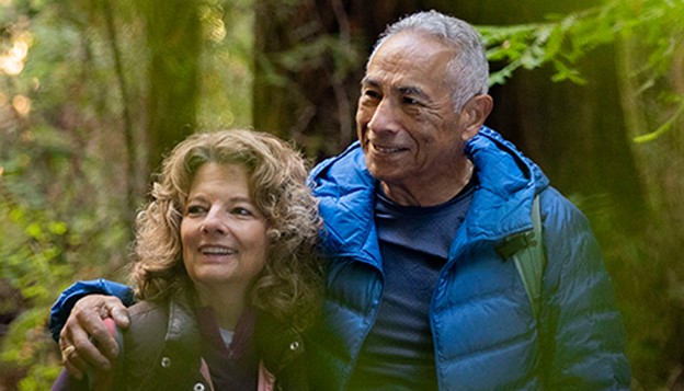 Richard, a patient living with early Alzheimer's, with his arm around his wife, Christine